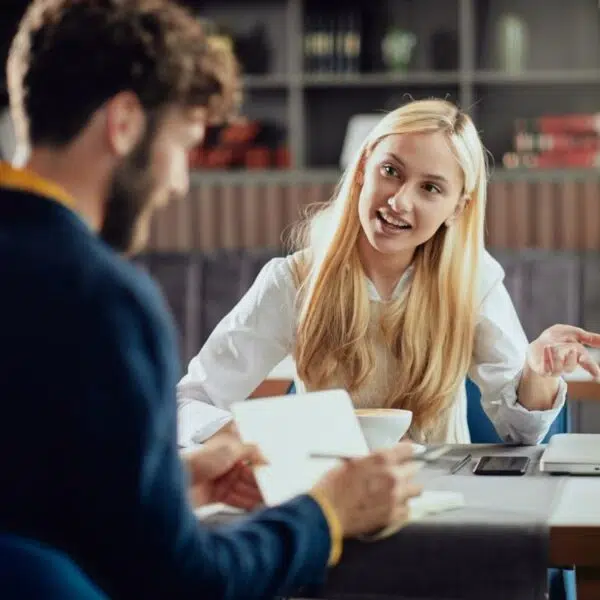 Zwei Personen im Gespräch über Business und persönliche Weiterentwicklung.